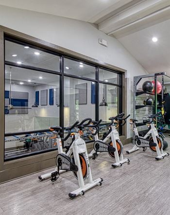 a group of exercise bikes in a gym